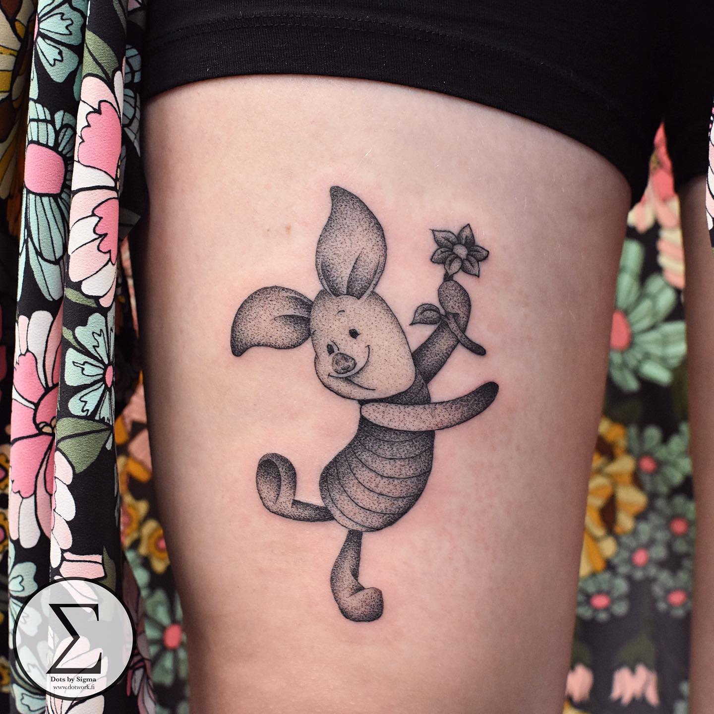 Dotwork tattoo of Piglet holding a flower and joyfully dancing on a person's thigh